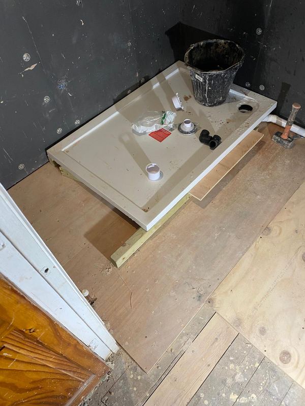 Shower tray installation on new subfloor by Magico Plumbing And Heating in Chelsea and Kensington