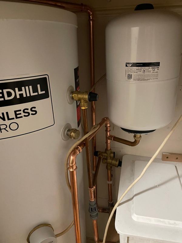 Redhill stainless steel unvented hot water cylinder installation with copper pipework by Magico Plumbing And Heating in Chelsea and Kensington